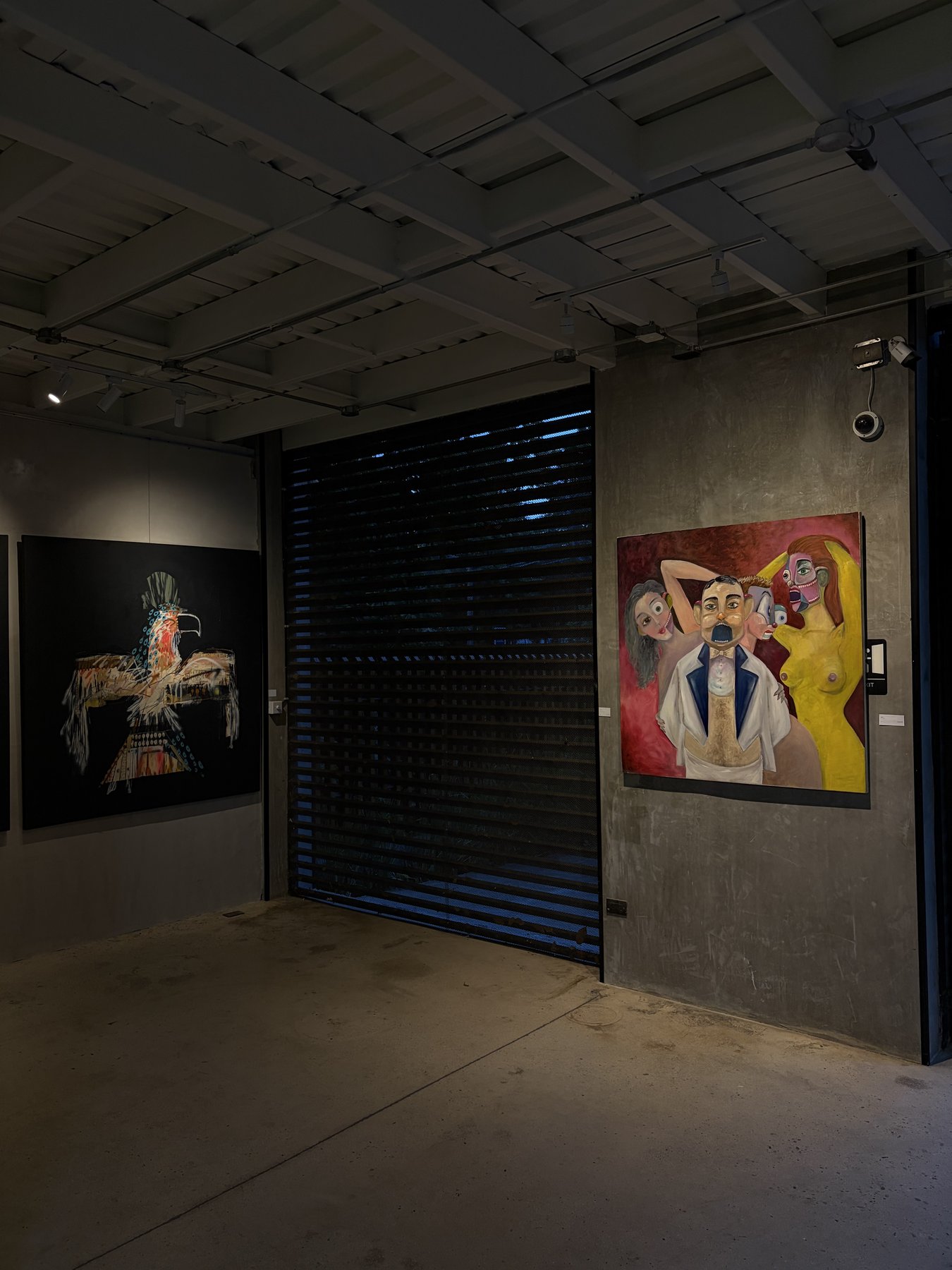 Gallery wall with bird painting and figurative work