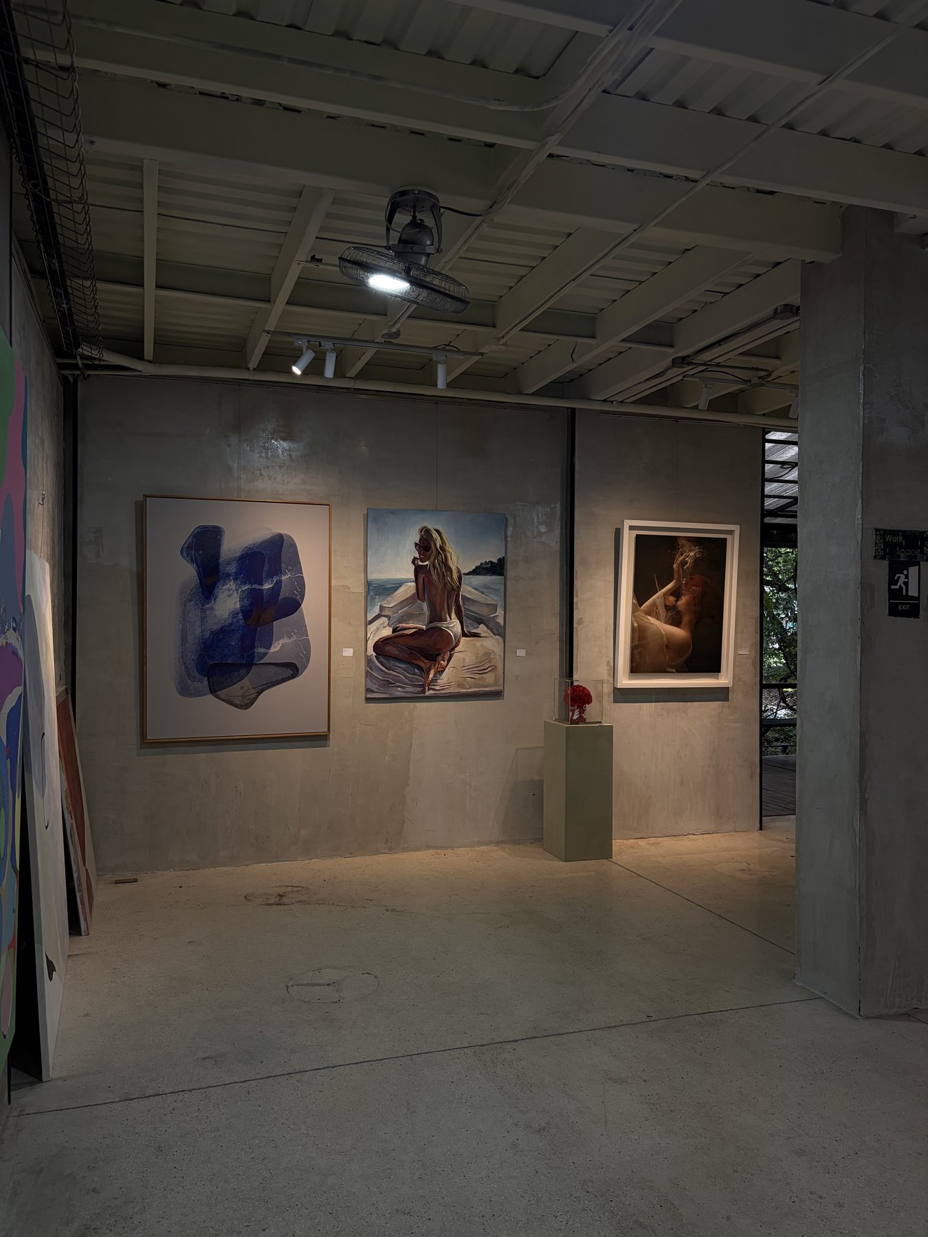Gallery corner with abstract painting and portraits