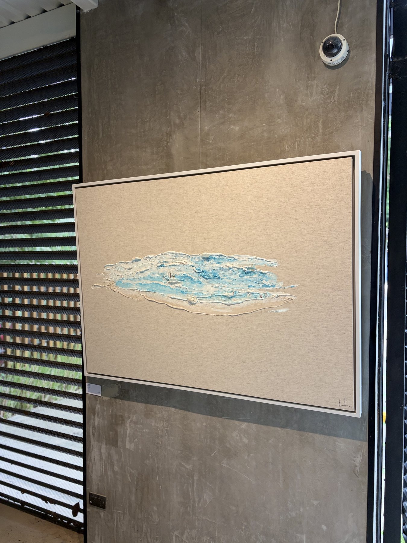 Textured ocean painting on concrete wall